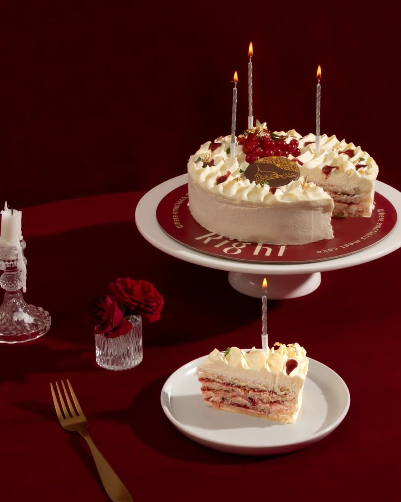 A Right celebration cake with candles on the branded cake stand